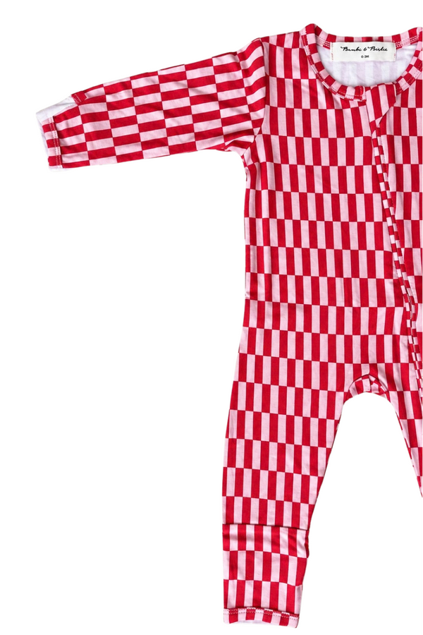 A baby long-sleeve footless one-piece romper with a red and white checkerboard pattern, laid flat on a white background.
