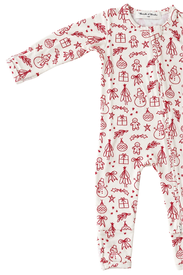 A long-sleeve baby footed sleeper with an all-over red Christmas-themed print on a white background, featuring illustrations of snowmen, gingerbread men, ornaments, stars, and gifts. The brand 'Breezeways' is visible on the inner neck label.